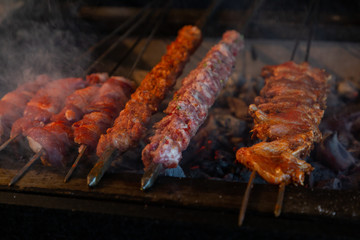 various kebabs on an open grill
