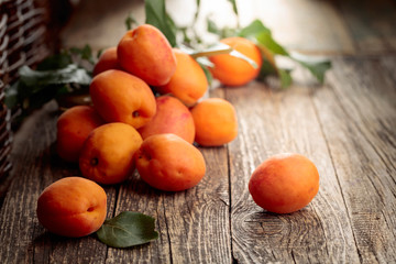 Naklejka na ściany i meble Fresh apricots on a old wooden table.