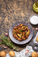 Baked young potatoes in a rustic style with sour cream