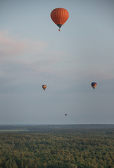 Four colorful balloons flying over the field using heat technology