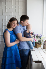 Happy Young Caucasian Family near Window