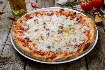 Pizza Quattro formaggi on wooden table