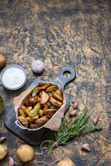 Baked young potatoes in a rustic style with sour cream