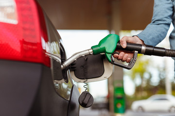 Crop hand refueling car on station