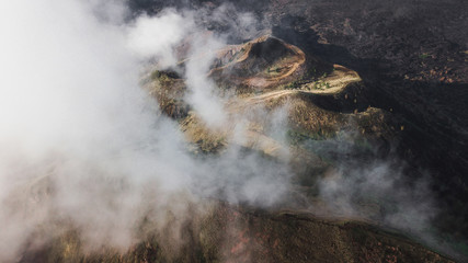 Aerial view of Batur volcano caldera in Bali. Volcanic black texture and crater rim, view from above, drone shot