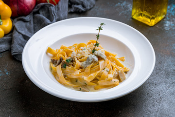 fettuccine with porcini mushrooms on dark concrete background