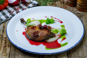 Duck leg confit with berry sause