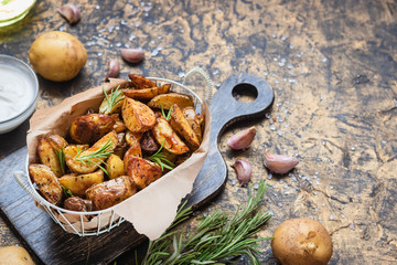 Baked young potatoes in a rustic style with sour cream