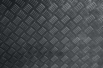 Corrugated dark and black pattern of non-slip ribbed metal or steel diamond plate rugged industrial...
