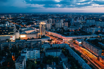 Aerial view of night European city Voronezh midtown or center panorama with modern buildings, drone shot from above