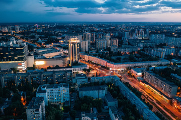 Fototapeta premium Aerial view of night European city Voronezh midtown or center panorama with modern buildings, drone shot from above