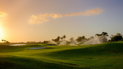 Golf course at sunset being watered on Grand Cayman, Cayman Islands