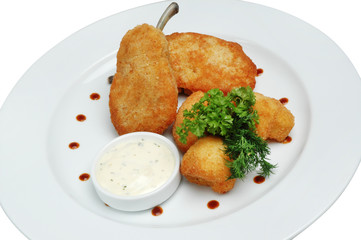 Nuggets on a plate with sauce and parsley, on a white isolated background