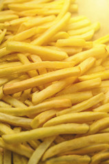 Crispy french fries on planks background, potato