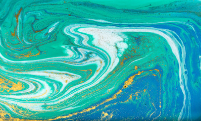 Blue, green and gold marbling pattern. Golden powder marble liquid texture.