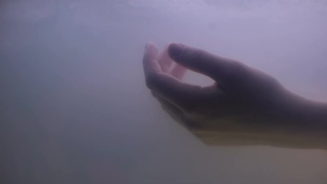 Female hand under dark water, drowned victim of suicide crime, life problem
