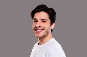 Fototapeta premium Friendly guy widely smiling at camera, semi half portrait