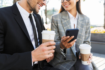 Two attractive smiling young office colleagues