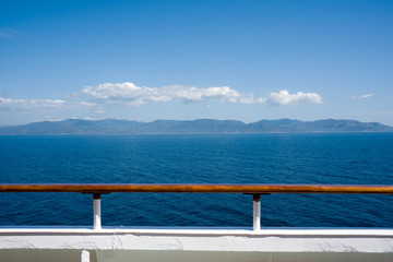 Distant coastline view from a ship deck