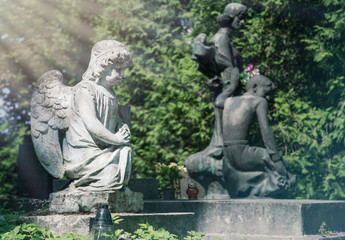 Marble statue and an ancient abandoned Gothic cemetery