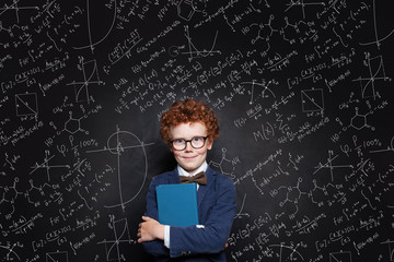 Happy child pupil against science background