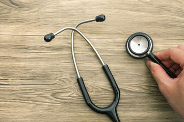 stethoscope on wooden background
