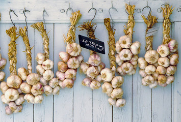 strings of garlic on old wooden background - Powered by Adobe