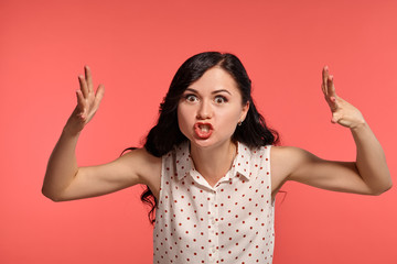 Studio shot of a lovely girl teenager posing over a pink background.