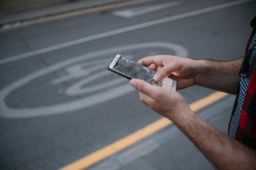 Male hands with the phone, navigation. Close-up.