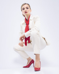 Fashion business model wearing a white suit and red accessories
