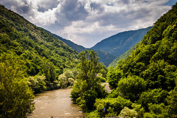 River through forest and mountains, cloudy sky. Ibar river in Serbia