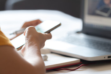 Soft focus Asian woman working on a laptop and mobile laying on the bed, Work any where or work at home concept