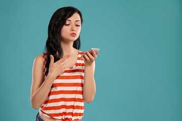 Studio photo of a gorgeous girl teenager posing over a blue background.