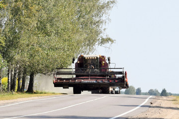 modern combine harvester moves by road © dzmitry_2014
