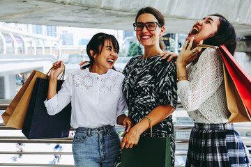 Beautiful three woman smile and happy for shopping in black Friday.