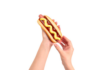 Hot dog in woman hand isolated on white background. Copy space.