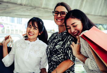 Beautiful three woman smile and happy for shopping in black Friday.