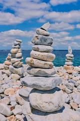 stone towers in front of a seascape in Camaret-sur-Mer in France on a sunny day with cloudy sky