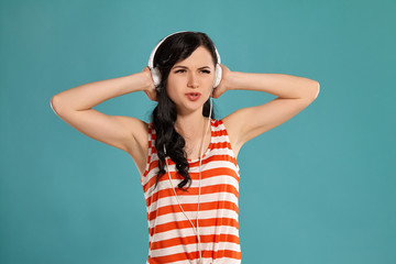 Studio photo of a gorgeous girl teenager posing over a blue background.