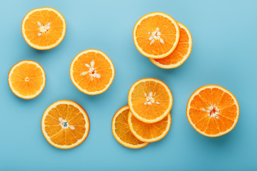 Slices and slices of orange pulp on a bright blue background as a textural background, the substrate. Full screen Flat lay, top view. Food background