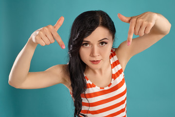 Studio photo of a gorgeous girl teenager posing over a blue background.
