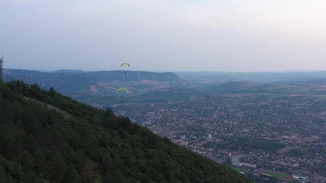 Paragliders over the city of Millau Aveyron France cloudy sunset aerial shot