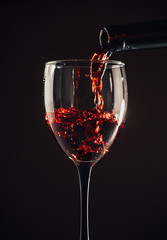 Naklejka na ściany i meble red wine pouring glass