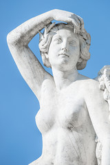 Old statue of sensual renaissance era woman at blue smooth background, Potsdam, Germany, details,...