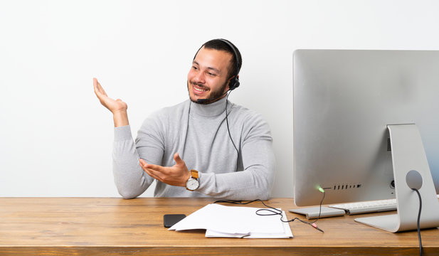 Telemarketer Colombian man extending hands to the side for inviting to come