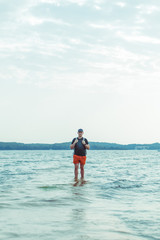 man standing in the sea water at beach