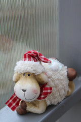 The smile teddy sheep and translucent corrugated plastic wall background.