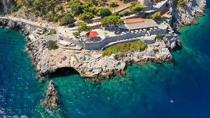 Aerial drone photo of beautiful turquoise rocky seascape of Hydroneta with picturesuqe windmill a famous swimming place near main village of Hydra or Ydra, Saronic gulf, Greece
