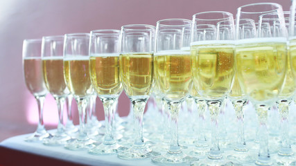 Champagne is poured into glasses before the event