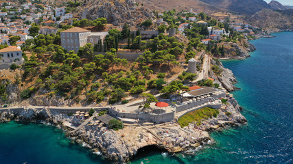 Aerial drone photo of beautiful turquoise rocky seascape of Hydroneta with picturesuqe windmill a...
